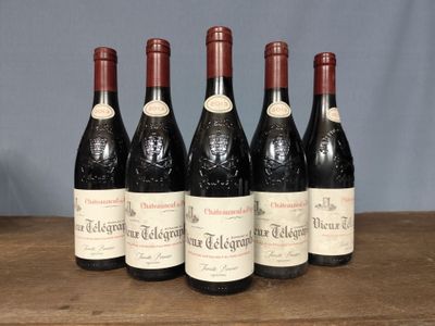 six bottles of wine are lined up on a wooden table