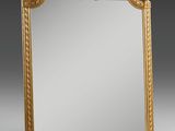 an antique gold framed mirror with scrolling scrolls and scrolls