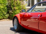 a red sports car parked in front of a house