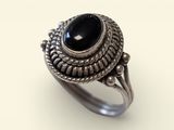 a silver ring with a black stone in the center