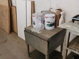 a small table with paint on it in a room