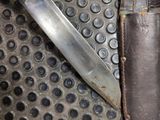 a knife that is laying on top of a piece of metal