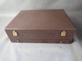 a brown suitcase that is sitting on a white sheet