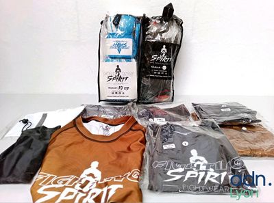 several t - shirts and a bag of coffee sit on a table