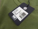 a green sweater with a price tag attached to it