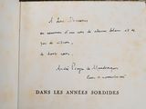 an old book with writing on it sitting on a table