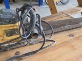 a chainsaw sitting on a wooden table in a workshop