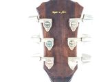 a close up of a guitar head on a white background