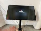 a flat screen tv sitting on a stand in a room
