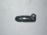 a small black object on a table with a white background