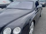 a picture of a black bentley car parked in a parking lot