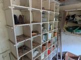 a room with a shelf full of items in it