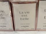 three boxes of lancomine perfume sitting on a table