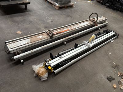 several pieces of metal are laying on the floor in a warehouse