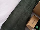 a box of wine sitting on the floor next to a bed