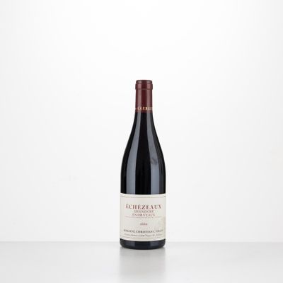 a bottle of red wine sitting on top of a table
