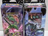 two boxes of pokemon trading cards are sitting on a table