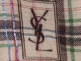 a close up of a plaid shirt with a monogram on it
