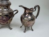 two silver vases sitting next to each other on a table