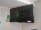 a flat screen tv mounted on the wall above a bed