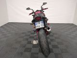 a motorcycle that is parked in a room with a checkered floor
