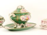 a green and white tea set with a cup and saucer
