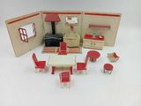a doll house with a table and chairs and a stove
