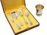 a box with silverware in it and a silver cup