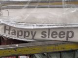 a sign that says happy sleep on the side of a bed