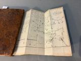 a book with a map on it sitting on a table