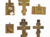 a group of four bronze crosses and other religious items
