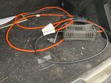wires in the trunk of a car with a charger in it
