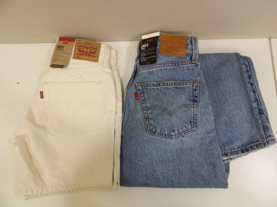 two pairs of levi ' s jeans are sitting on a counter