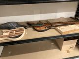 une étagère sur laquelle se trouvent une guitare, un étui à guitare et d'autres instruments de musique