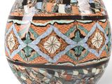 a vase that is sitting on a white surface