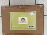a box with a picture of a bird on it on a tiled floor