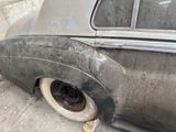 an old car that is sitting on the side of the street
