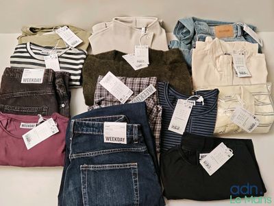 many pairs of jeans on a table with price tags on them