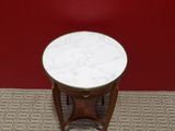 an image of a small table with a marble top on a carpeted floor