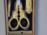 a pair of scissors and a pair of scissors in a box
