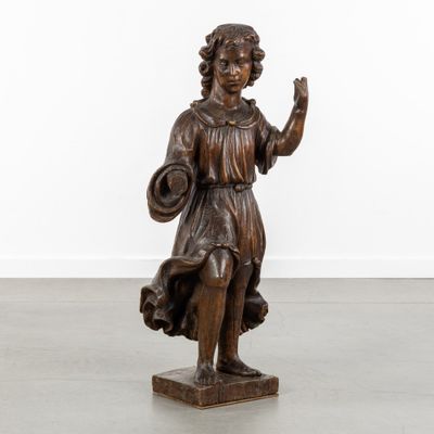an antique bronze statue of a woman holding a basket