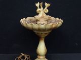 a bird that is sitting on top of a fountain