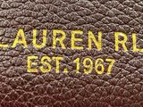 a close up of a brown leather purse with a name on it