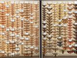 two rows of beads on display in a store window
