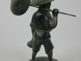 a figurine of a man with a hat on his head
