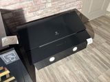 a black television sitting on top of a wooden table