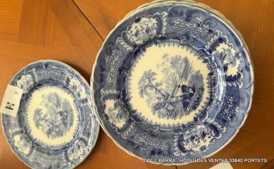 two blue and white plates on a wooden table with a price tag
