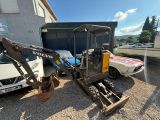 a small excavator parked in front of a building