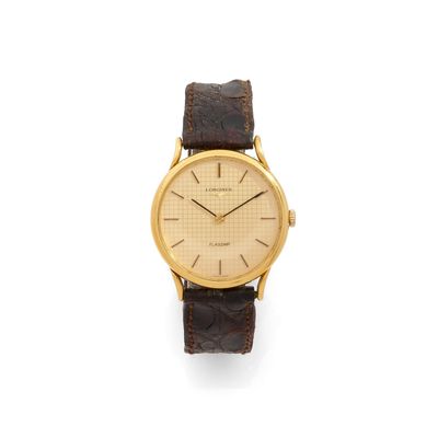 a gold plated wrist watch with brown leather strap