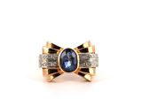 a close up of a ring with a blue stone and diamonds